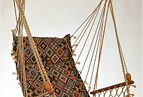 Hanging rocking chair from Czech company Alebo  from tapestry fabrics